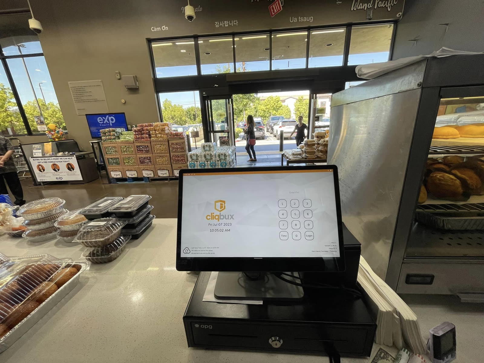 Cliqbux point of sale terminal running at a grocery store checkout counter